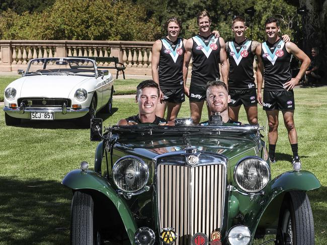 AFL - Port Adelaide Football Club announce a new major sponsor - Car dealer MG. - at Montefiore Hill. Connor Rozee and Robbie Gray in an historic MGC with Xavier Duursma, Tom Jonas, Hamish Hartlett and Tom Rockliff in the background. Picture SARAH REED