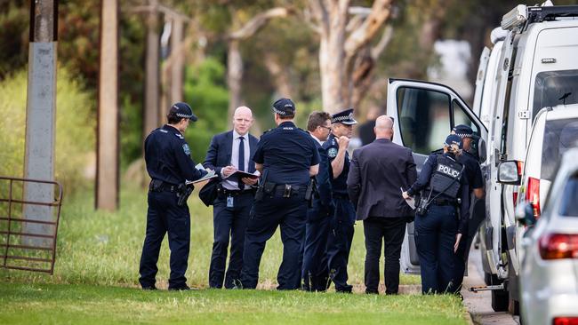 Officers and detectives at the scene where human remains were discovered at a vacant block in Salisbury South. Picture: Tom Huntley