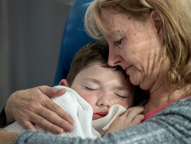 Fawna Lennon comforts her grandson Jayden Ryan, 7, as he recovers from surgery to have teeth removed. Picture: Jake Nowakowski