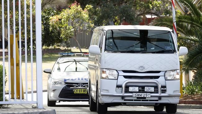 The coroner’s van followed by a police car begins Ivan Milat’s final journey, from Long Bay to the morgue. Picture: Chris Pavlich/The Daily Telegraph