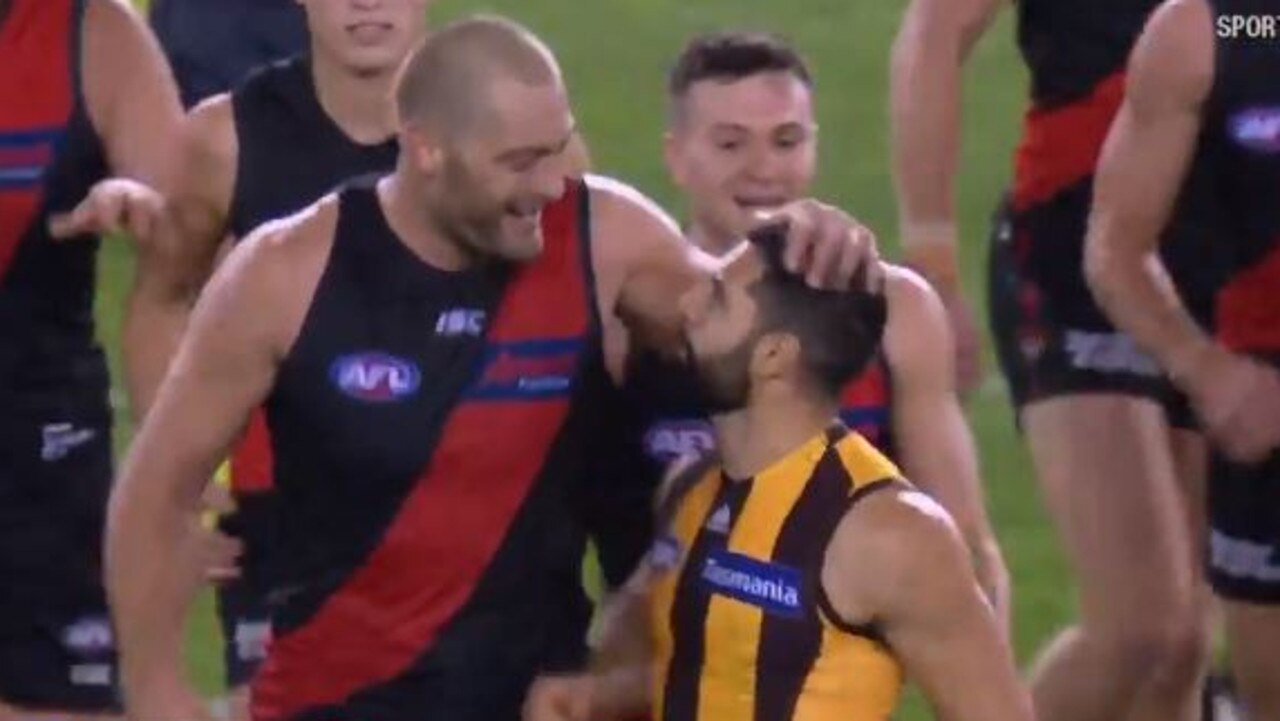 Tom Bellchambers laughs after being confronted by Paul Puopolo at three quarter-time.