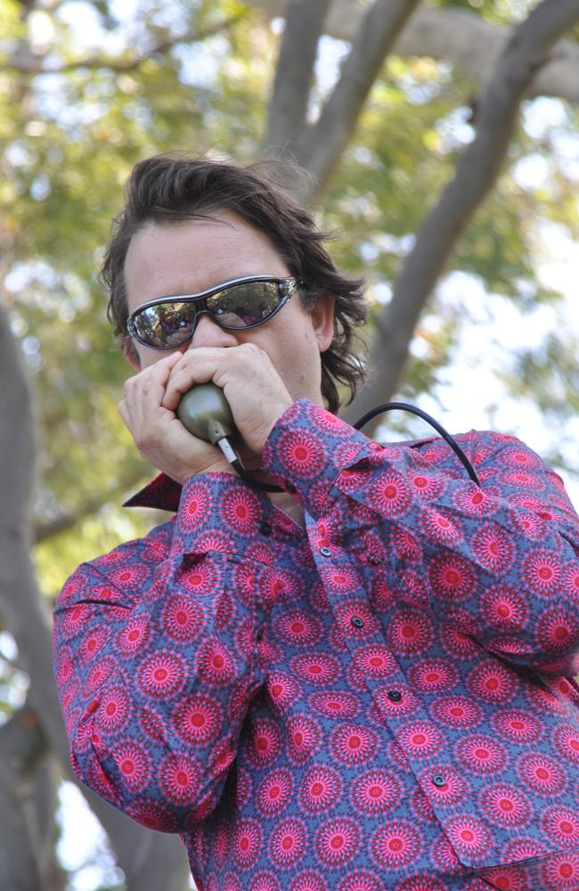 The Muddies’ harmonica player Gaston Boulanger plays the blues at the Beach Arts and Music Festival's Hippie Day at the Tannum Sands Esplanade. Photo Chantal Bax / The Observer