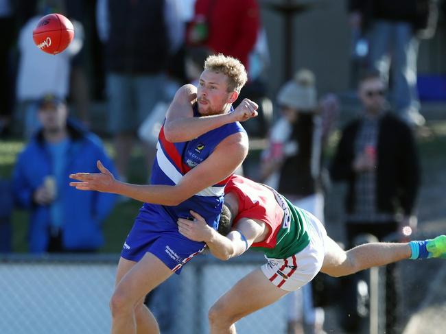 Jackson Calder fires out a handball for Mornington. Picture: David Crosling