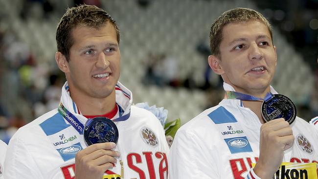 Russian swimmers Nikita Lobintsev, left, and Vladimir Morozov hold up their silver medals at the Swimming World Championships