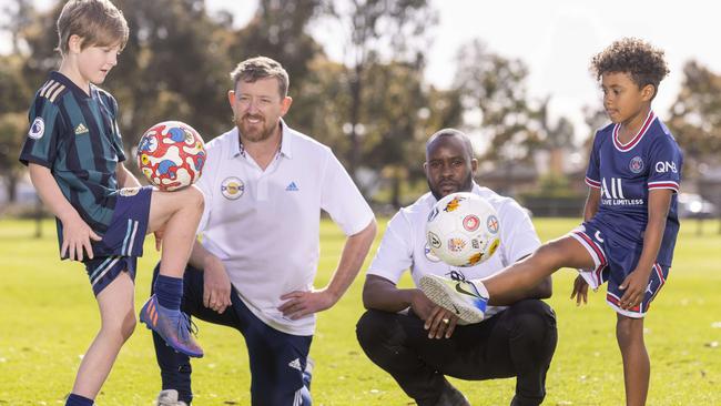 Tim Quinn (left) and Peter Mazalla want to set up a new, more affordable soccer club in Adelaide. They are pictured with their children Fred and Zion. Picture: Kelly Barnes