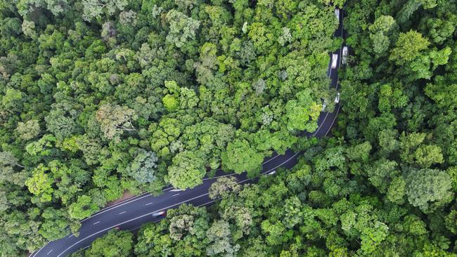 Aerial view of the Kennedy Highway snaking through World Heritage listed rainforest up the McAllister Range. This section of the highway is commonly referred to as the Kuranda Range Road, and is the main transport route from Cairns to the Atherton Tablelands, west to the Gulf and north to Cape York. Thousands of cars, tourist coaches and trucks traverse the Kuranda Range Road each day. The route can be hazardous in wet weather, with the roadway becoming slippery and trees and rocks commonly falling over the road. Picture: Brendan Radke