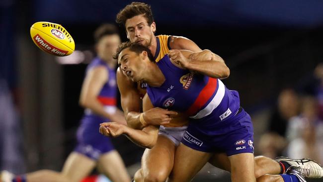 MELBOURNE, AUSTRALIA - MAY 7: Luke Dahlhaus of the Bulldogs is tackled by Kyle Hartigan of the Crows during the 2016 AFL Round 07 match between the Western Bulldogs and the Adelaide Crows at Etihad Stadium, Melbourne on May 7, 2016. (Photo by Michael Willson/AFL Media/Getty Images)