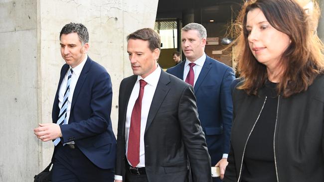 NAB wealth executive general manager Paul Carter, centre, leaves after giving evidence at the financial services royal commission in Melbourne today.