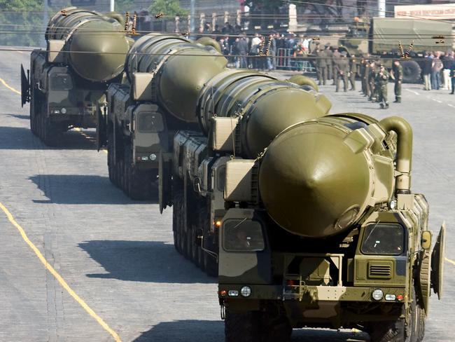 Moscow, Russia - May 5, 2008: Russian policeman stands in front of convoy of nuclear missiles "Topol-M" in military parade rehearsal on Red Square, Moscow
