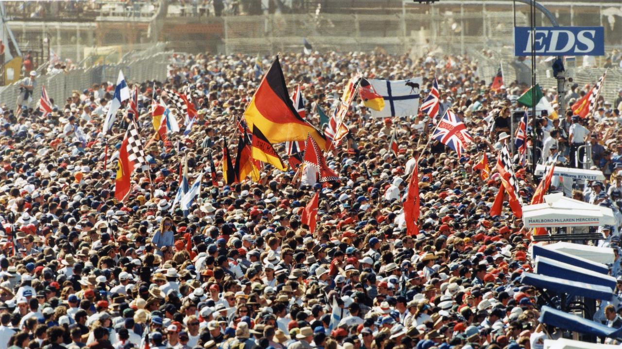 Members of the record 210,000-strong crowd flood the home straight as they wait for the trophy presentations at Adelaide’s final Grand Prix in 1995. Picture: Greg Adams