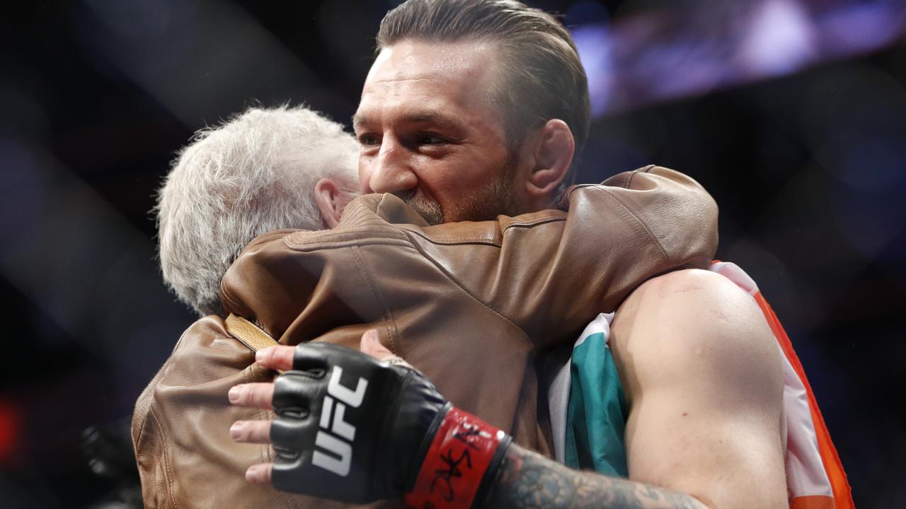 Conor McGregor, right, embraces Jerry Cerrone, the grandmother of Donald "Cowboy" Cerrone.