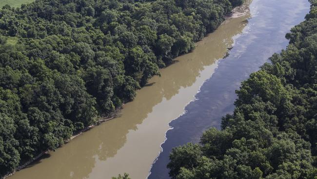 Bourbon mixes with water in the Kentucky River following the warehouse blaze. Picture: AP