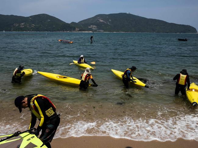 People use sea kayaks on a beach in Hong Kong as beaches open after the government eased some of the Covid-19 restriction. Picture: AFP.