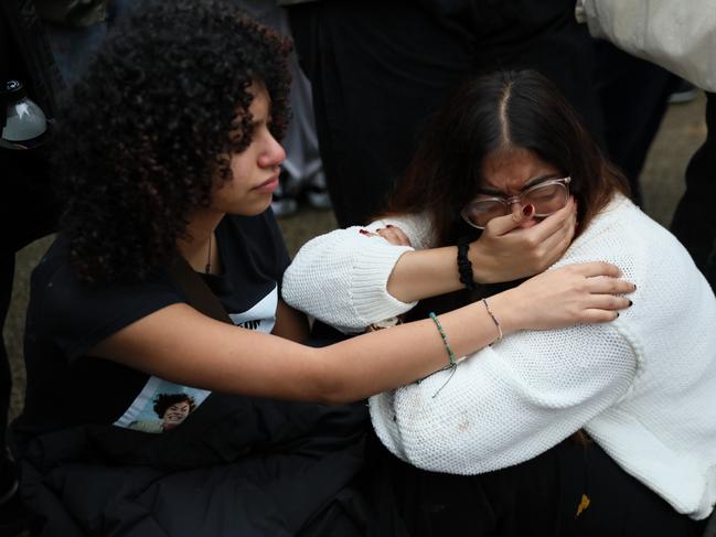 London: Fans react as they gather at the Peter Pan statue during a tribute event for One Direction singer Liam Payne in Hyde Park. Picture: Getty Images