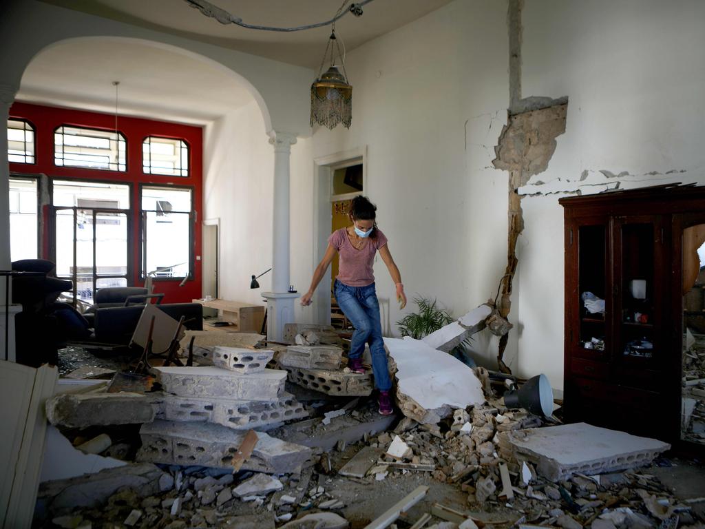 A Lebanese woman walks over the rubble in her apartment in the neighbourhood of Gemmayze. Picture: Patrick Baz/AFP