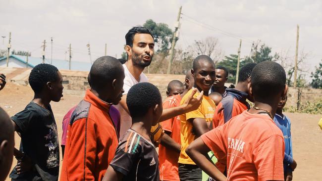 *** EMBARGOED FOR SA WEEKEND - PLEASE DO NOT USE - SPEAK TO MICHAEL MCGUIRE OR SA PIC DESK *** Former Adelaide United footballer Marcos Flores in Africa teaching football to children. Source. Supplied by marcos Flores. -  Madagascar prison - Tanzania - South Africa- Kibera/ Nairobi - Marcos Flores