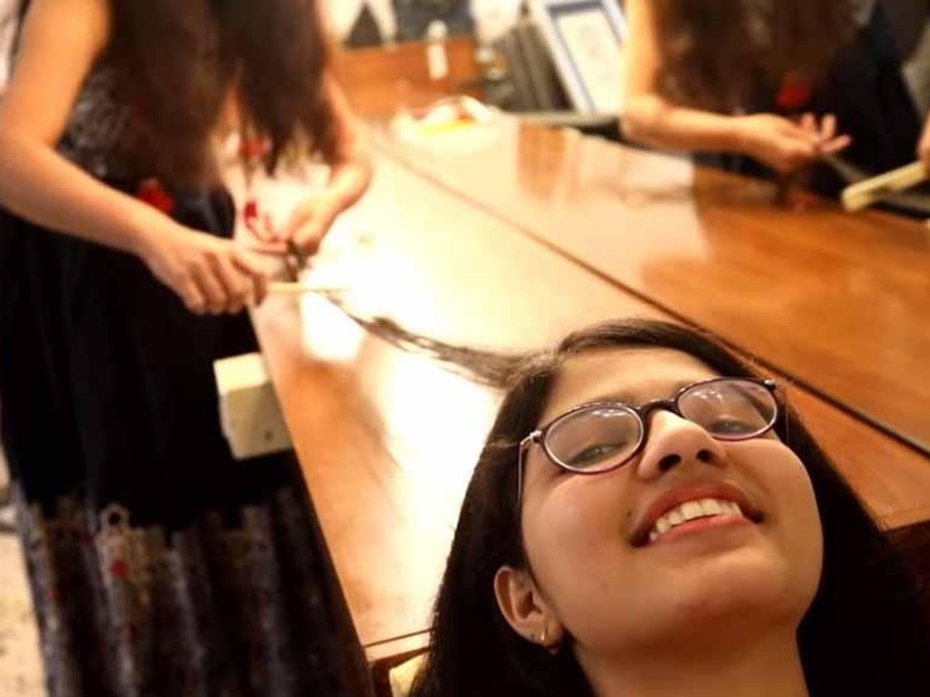 Nilanshi Patel, a 16-year-old girl from Gujarat, India, has her record-breaking hair combed. Picture: Guinness World Records