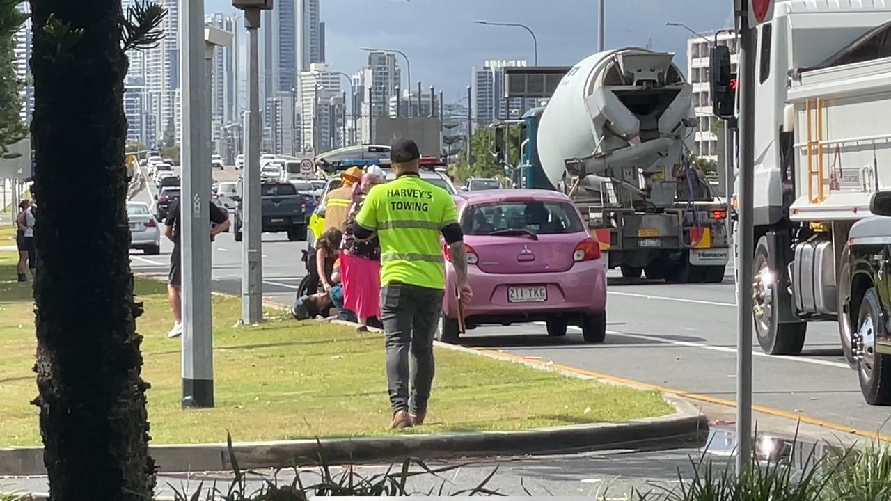 A man is being treated by paramedics following a car and motorbike crash on the Gold Coast Highway in Southport. Photo: Charlton Hart