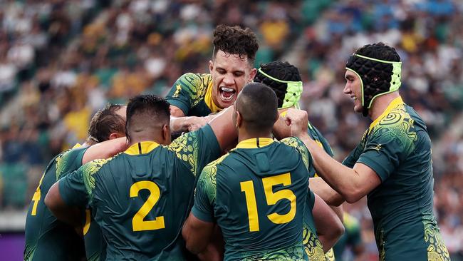 OITA, JAPAN - OCTOBER 05: James Slipper (obscured) of Australia is congratulated by his team mates after scoring his side's sixth try during the Rugby World Cup 2019 Group D game between Australia and Uruguay at Oita Stadium on October 05, 2019 in Oita, Japan. (Photo by Dan Mullan/Getty Images)