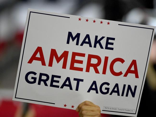 HENDERSON, NEVADA - SEPTEMBER 13: A supporter holds up a "Make America Great Again" sign during a campaign event for U.S. President Donald Trump at Xtreme Manufacturing on September 13, 2020 in Henderson, Nevada. Trump's visit comes after Nevada Republicans blamed Democratic Nevada Gov. Steve Sisolak for blocking other events he had planned in the state.   Ethan Miller/Getty Images/AFP == FOR NEWSPAPERS, INTERNET, TELCOS & TELEVISION USE ONLY ==