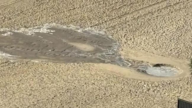 A two metre hole erupted in the middle of Main Beach. Picture: Supplied