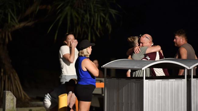 A teenage girl has died after being bitten by a shark off Bribie Island. Family and friends gather at the site. Picture: Patrick Woods.