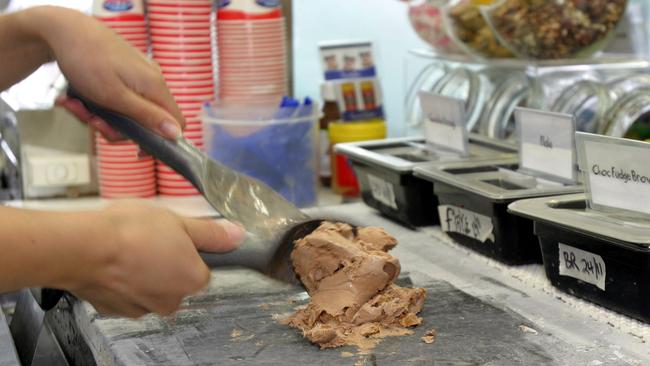 A Cold Rock worker mixes ice cream on the company’s signature ‘cold rock’.