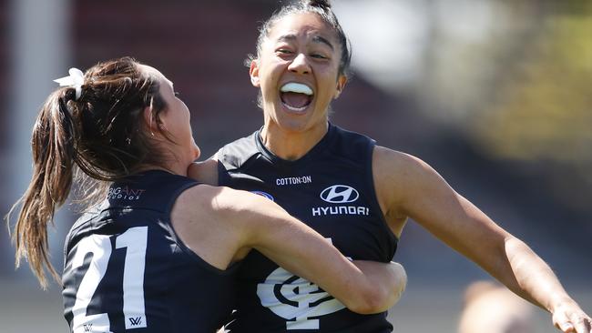 Georgia Gee and Vescio celebrate a goal against Fremantle at Ikon Park last season.