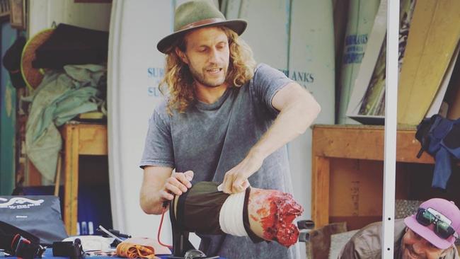 Dr Jon Cohen at a necessarily realistic demonstration of how to use a tourniquet on a shark attack victim. Picture: Supplied