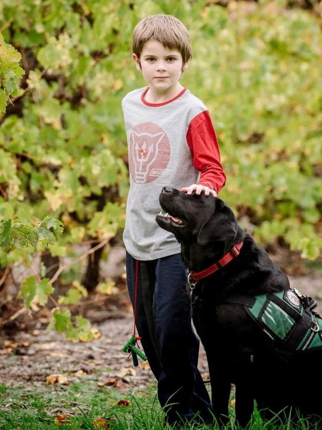 Munno Para West boy Phoenix Ringrose with his autism assistance dog Jimmy. Picture: Supplied