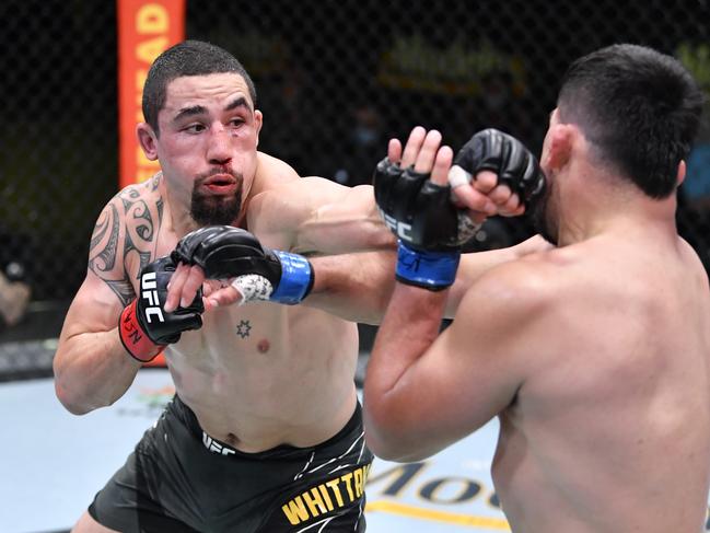 LAS VEGAS, NEVADA - APRIL 17:  In this handout photo, (L-R) Robert Whittaker of Australia punches Kelvin Gastelum in a middleweight fight during the UFC Fight Night event at UFC APEX on April 17, 2021 in Las Vegas, Nevada. (Photo by Chris Unger/Zuffa LLC)