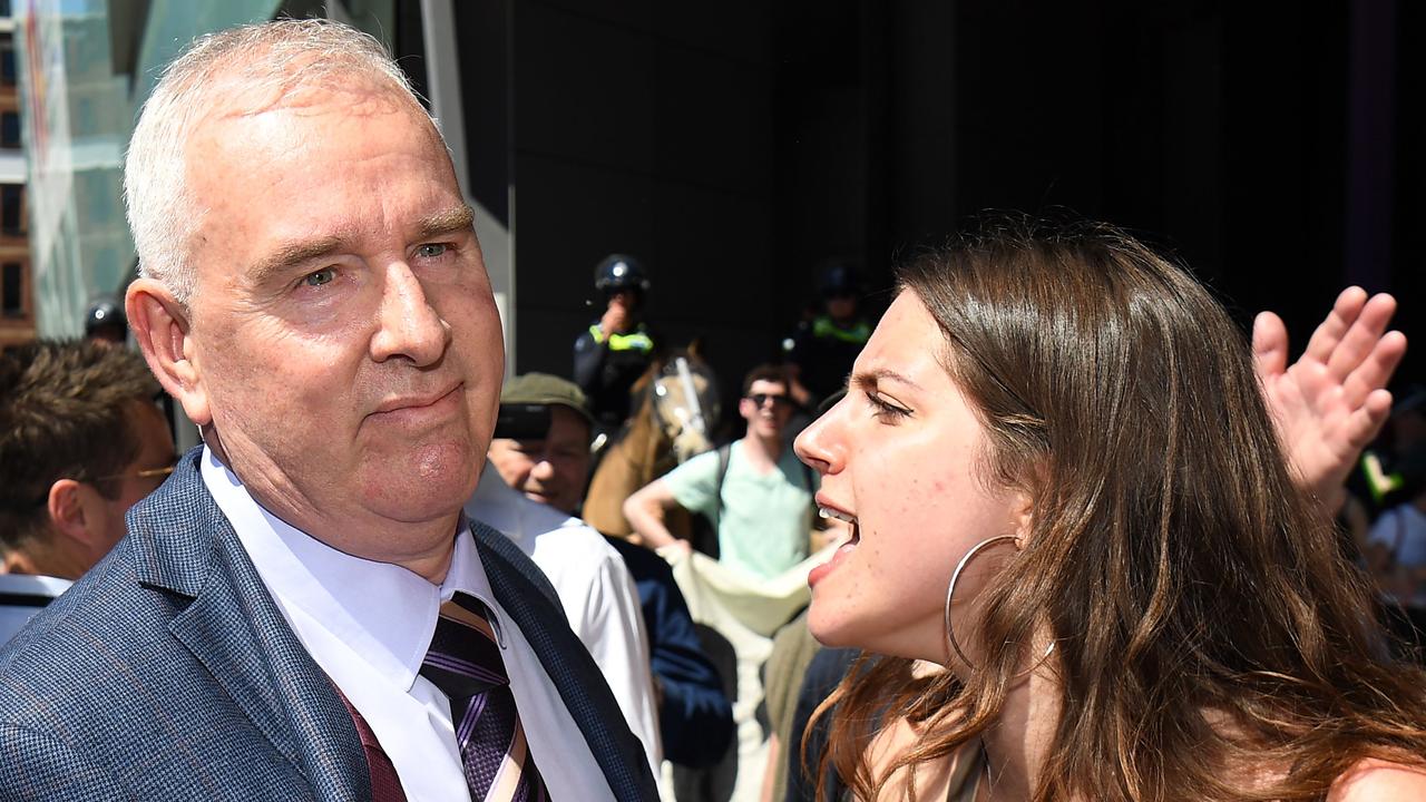 A climate change protester confronts a delegate at IMARC. Picture: William West/AFP