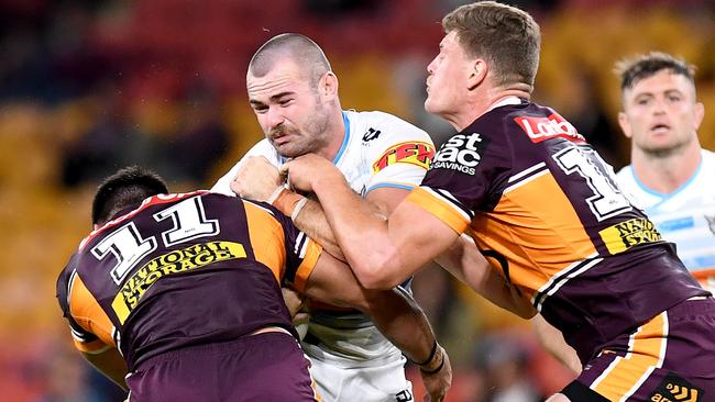 BRISBANE, AUSTRALIA - JUNE 27: Keegan Hipgrave of the Titans takes on the defence during the round seven NRL match between the Brisbane Broncos and the Gold Coast Titans at Suncorp Stadium on June 27, 2020 in Brisbane, Australia. (Photo by Bradley Kanaris/Getty Images)