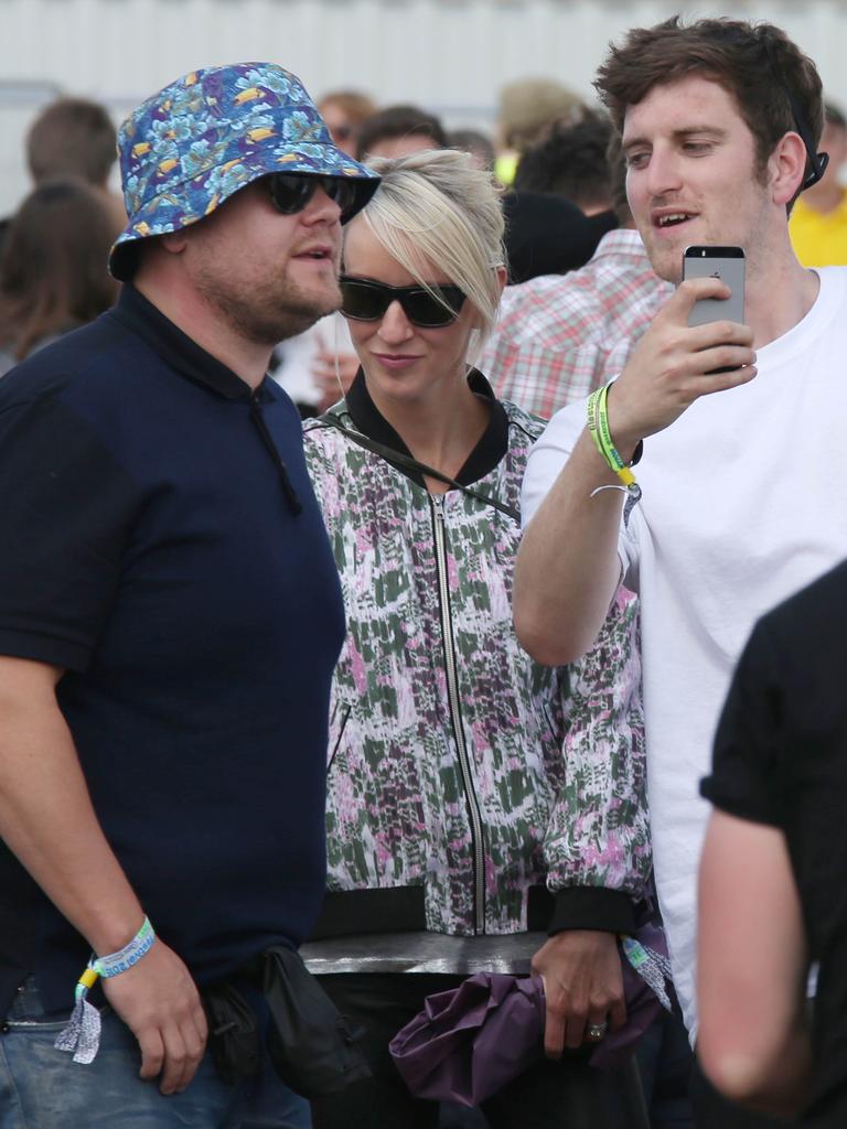 Comedian James Corden and wife Julia Carey are stopped for a selfie backstage during the 2015 Glastonbury Festival. Picture: AAP