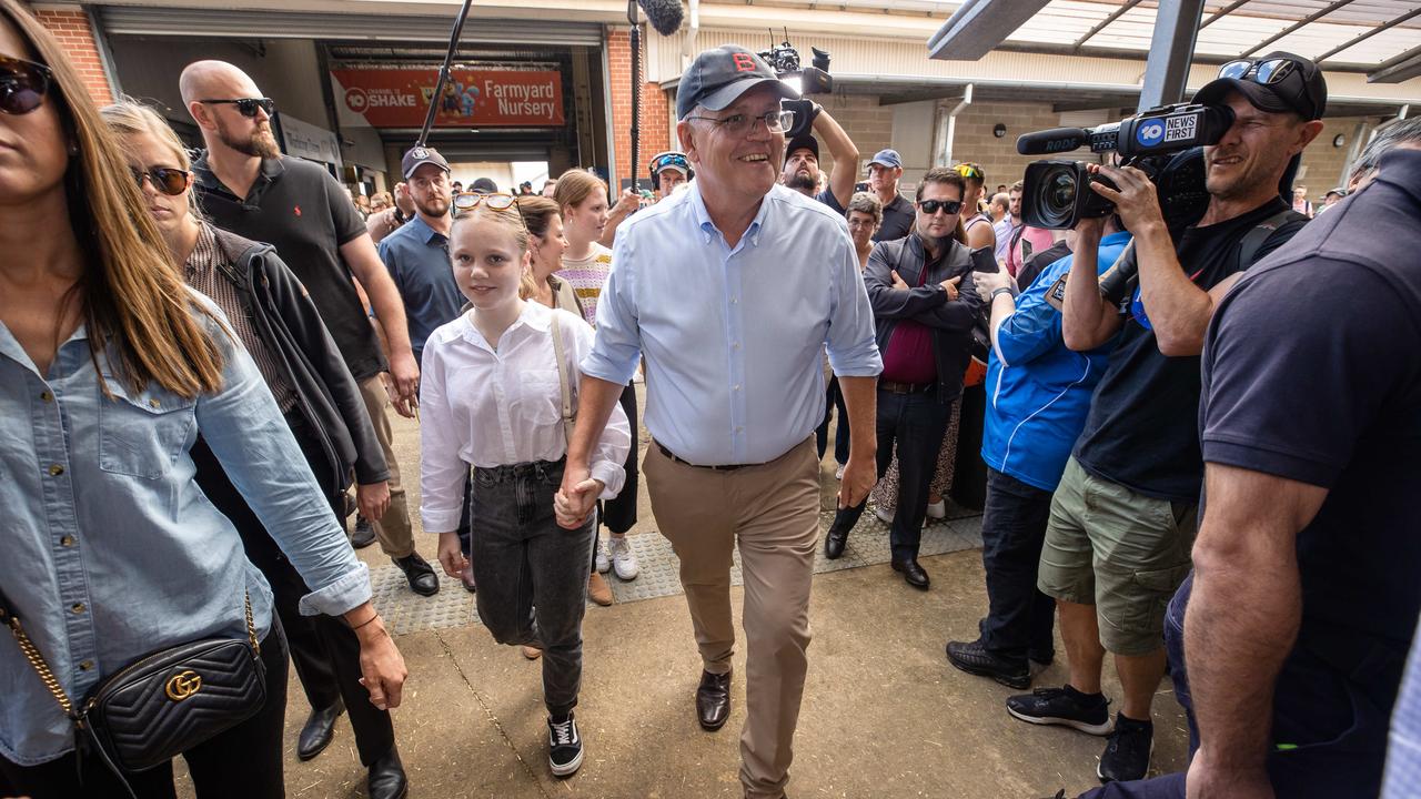 The PM holds his daughter’s hand. Picture: Jason Edwards