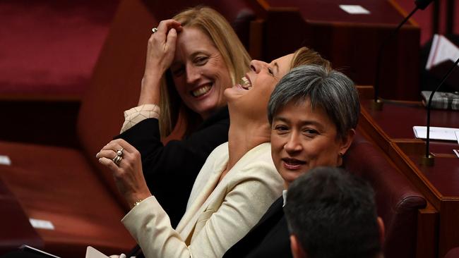 Senator Katy Gallagher, left, Senator Kristina Keneally, centre, and Senator Penny Wong, right, in the Senate.