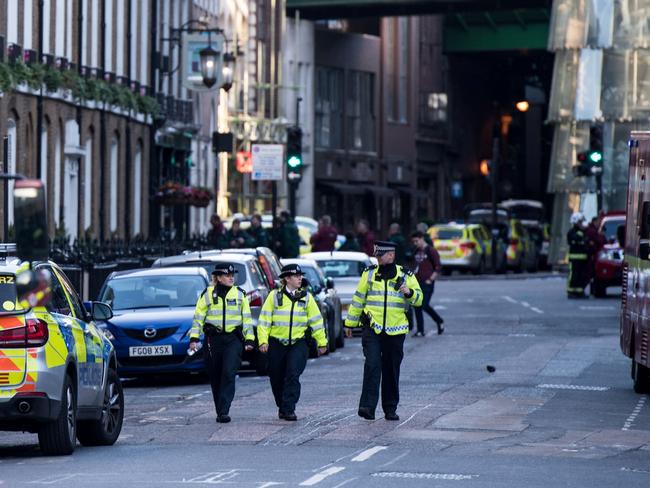 Police officers and emergency response vehicles are seen on the street outside Borough Market the morning after a terror attack. Picture: AFP