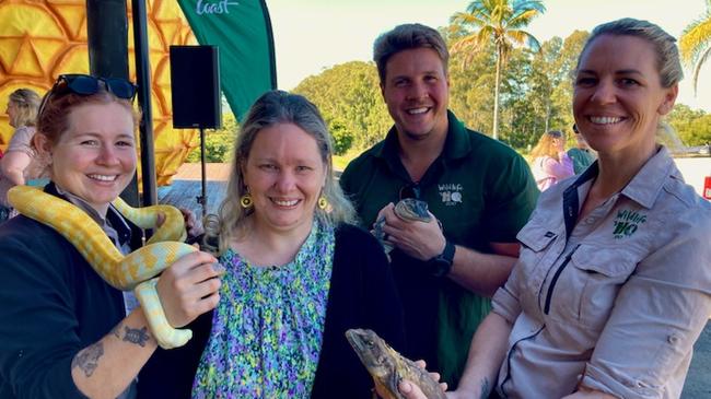 Big Pineapple grand opening - Shontel Brake from Mooloolaba met the team from Wildlife HQ (from left) Hannah McCracken with Zeus the albino Darwin carpet python, Matt Elliott with American alligator Florida and Nikki Mikula with Jakko the frill neck lizard. Photo: Michele Sternberg/Visit Sunshine Coast