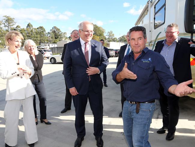 Prime Minister Scott Morrison (centre) and Employment Minister Michaelia Cash (left) speak with Serious Waste owner Floyd Hastie on the Gold Coast. Picture: Richard Gosling