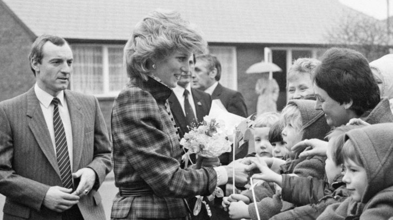Princess Diana and behind her, her bodyguard Barry Mannakee with whom she was becoming very close. Picture: Kent Gavin/Daily Mirror/Mirrorpix/Getty Images.