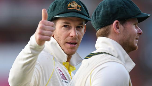 Australia's captain Tim Paine (L) gestures beside Australia's Steve Smith as his players celebrate their victory on the field after the fourth Ashes cricket Test match between England and Australia at Old Trafford in Manchester, north-west England on September 8, 2019. - Australia retained the Ashes with a 185-run thrashing of England in the fourth Test at Old Trafford on Sunday. (Photo by Oli SCARFF / AFP) / RESTRICTED TO EDITORIAL USE. NO ASSOCIATION WITH DIRECT COMPETITOR OF SPONSOR, PARTNER, OR SUPPLIER OF THE ECB