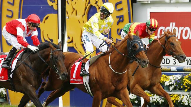 Michael Walker celebrates his win on Criterion in the Caulfield Stakes ahead of Happy Trails. Picture: Colleen Petch