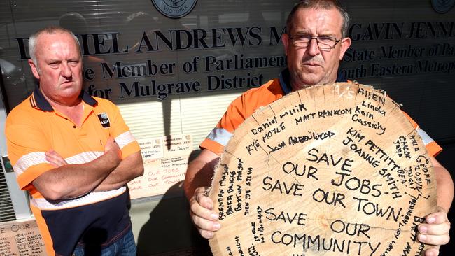 Brett Bould and Anthony Wilkes deliver some timber from the Heyfield Mill to Daniel Andrews Electoral office in Noble Park. The timber has messages to the Premier. Picture: Nicole Garmston