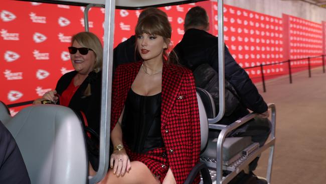 Taylor Swift rides on a golf cart with her parents prior to a game between the Kansas City Chiefs and the Denver Broncos. Picture: Getty Images