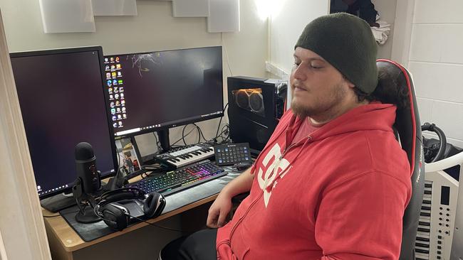 Justin Paiaro with his broken computer screen which was damaged during a ransack attack. Picture: Andreas Nicola