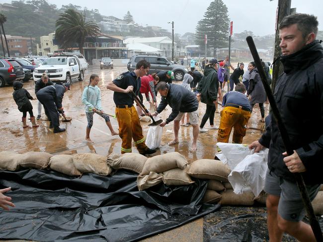 Surf club members, locals and firefighters laid sandbags to protect the Avoca Beach Surf Club / Picture: Troy Snook