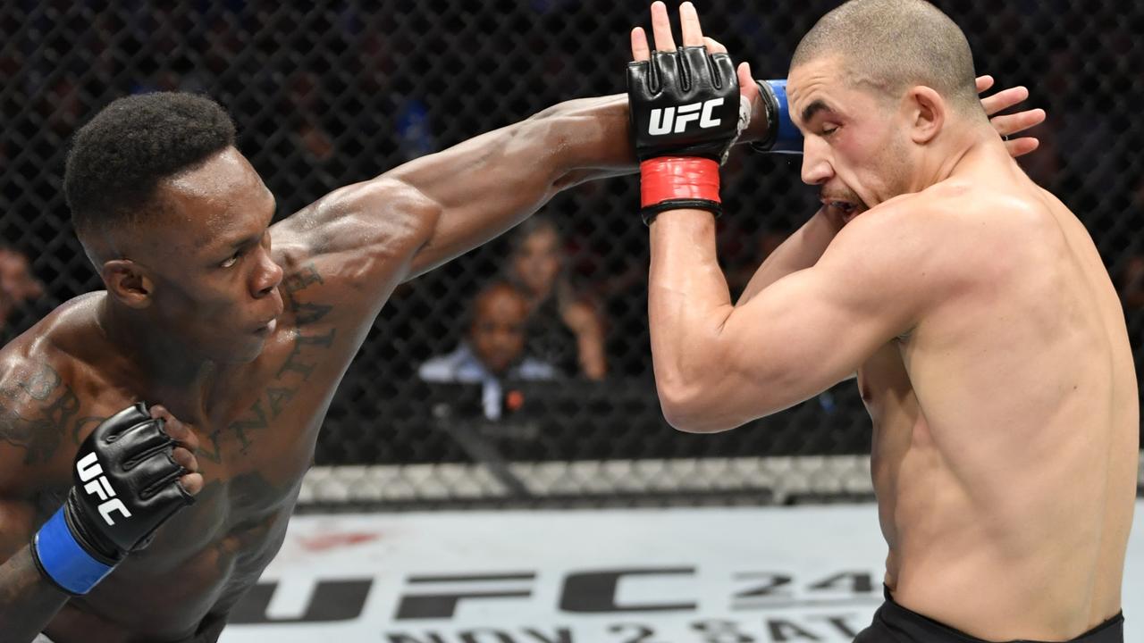 Israel Adesanya lands a blow on Robert Whittaker in their UFC middleweight championship fight at Marvel Stadium, Melbourne, in 2019.