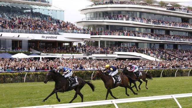 MELBOURNE, AUSTRALIA - NOVEMBER 01: Mark Zahra riding #1 Gold Trip leads Patrick Moloney riding #17 Emissary and Teo Nugent riding #22 High Emocean to win race seven, the Lexus Melbourne Cup during 2022 Melbourne Cup Day at Flemington Racecourse on November 01, 2022 in Melbourne, Australia. (Photo by Daniel Pockett/Getty Images)