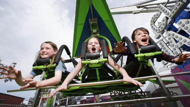 Joy riders Gabe 9, Emily 9 and Marley 9 on the Cliff Hanger ride for young kids at the Royal Melbourne Show. Picture: David Caird