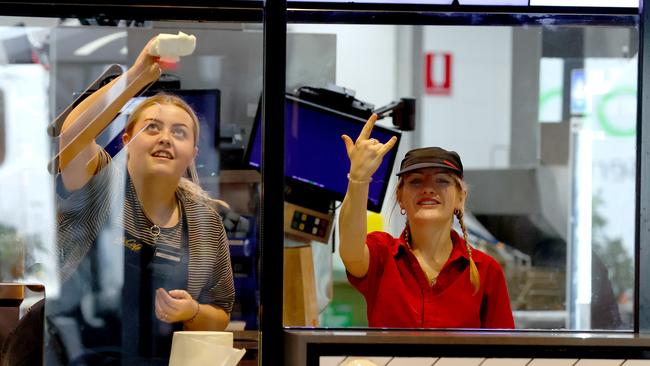 Hindley Street McDonald’s workers behind the newly installed plastic screens at the store. Picture: Kelly Barnes